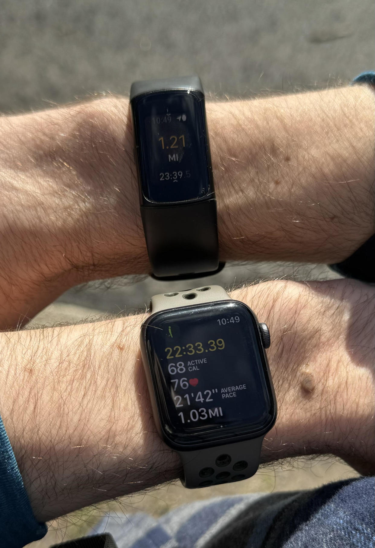 Close up shot of the Fitbit Charge 6 and Apple Watch SE screens on the left and right wrists of the writer. (Courtesy Harry Rabinowitz)