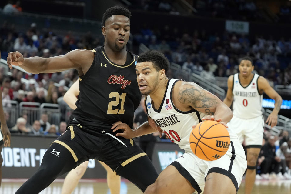 San Diego State guard Matt Bradley (20) gets around Charleston guard Jaylon Scott (21) during the first round of the NCAA tournament on Thursday, March 16, 2023, in Orlando, Fla. (AP Photo/Chris O'Meara)