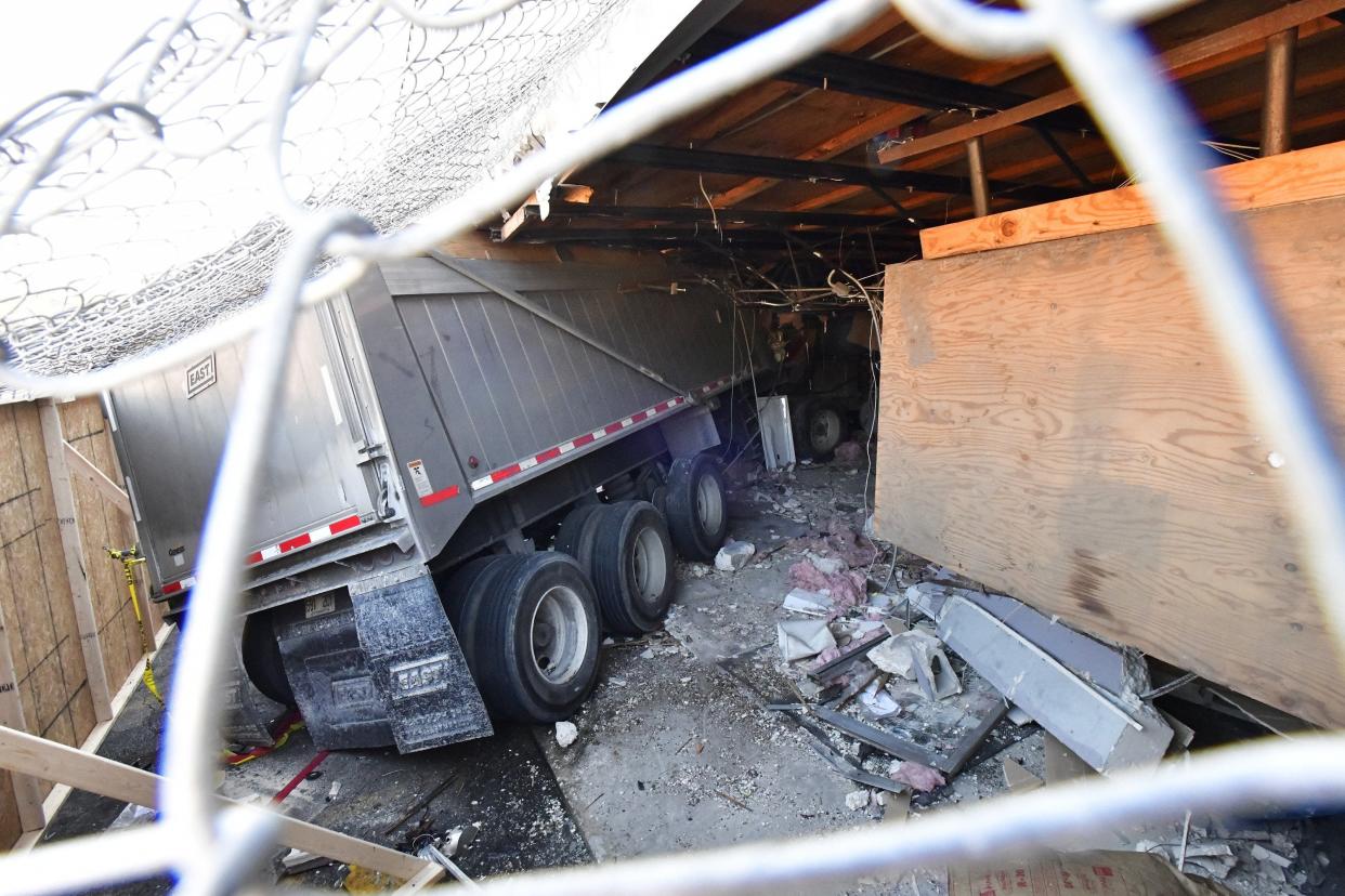 A semi-dump truck remains inside Bennett's Ace Hardware on West Beaver Street in Jacksonville's Marietta community Wednesday. It slammed into a car and through the front wall late Friday, injuring the two drivers and a passenger and business owner/brothers Keith and Dennis Bennett who were inside the store.
