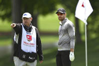 Patrick Rodgers, right, receives advice from his caddie on the 15th green during the second round of the Wells Fargo Championship golf tournament at Quail Hollow Club in Charlotte, N.C., Friday, May 7, 2021. (Jeff Siner/The Charlotte Observer via AP)