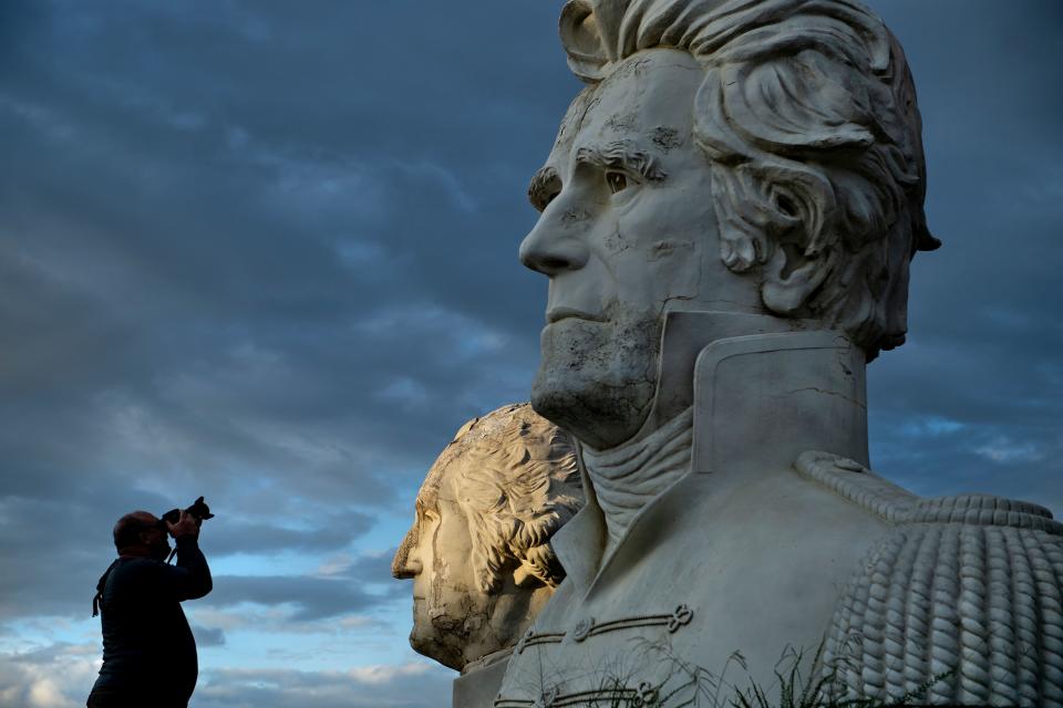 George Washington and Andrew Jackson can be seen as a man takes a photo of decaying busts of former US Presidents during a night photography workshop organized by John Plashal August 25, 2019, in Williamsburg, Virginia.(Photo: Brendan Smialowski/AFP/Getty Images)