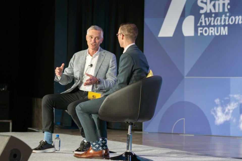 American Airlines CEO Robert Isom (left) speaking on stage at Skift Aviation Forum in Dallas, Texas, November 2022.  Skift