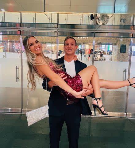 Meghan Haila Instagram Caeleb Dressel holding his wife, Meghan Haila.