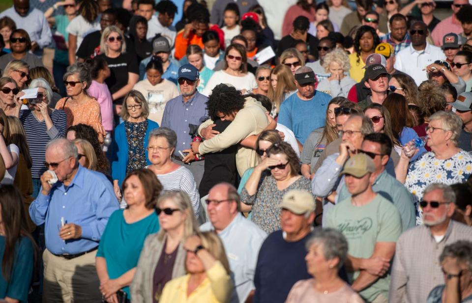 Community members embrace during a prayer vigil at First Baptist Church in Dadeville, Ala., on April 16, 2023.