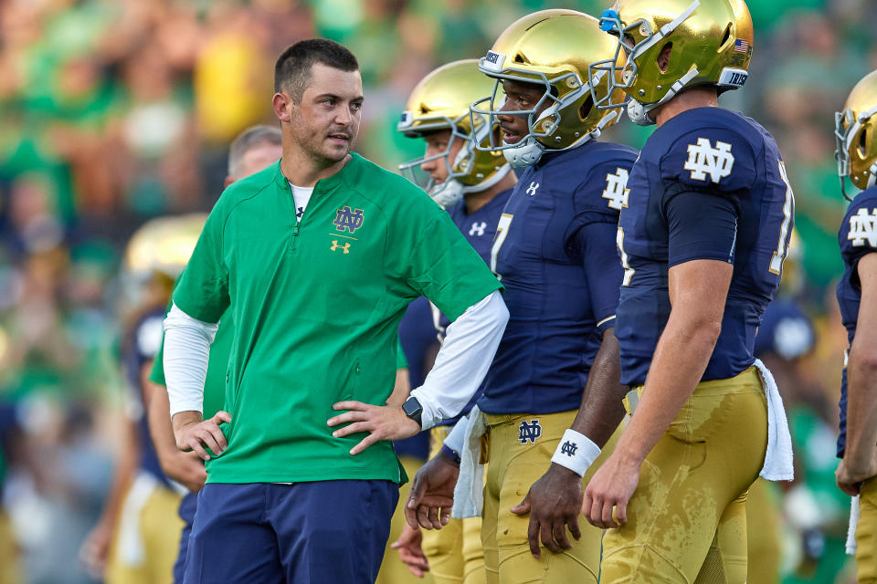 SOUTH BEND, IN - SEPTEMBER 01: Notre Dame Fighting Irish quarterbacks coach Tommy Rees talks to Notre Dame Fighting Irish quarterback Brandon Wimbush (7) during warm ups prior to game action of the NCAA football game between the Michigan Wolverines and the Notre Dame Fighting Irish on September 1, 2018 at Notre Dame Stadium, in South Bend, Indiana. The Notre Dame Fighting Irish defeated the Michigan Wolverines by the score of 24-17. (Photo by Robin Alam/Icon Sportswire via Getty Images)