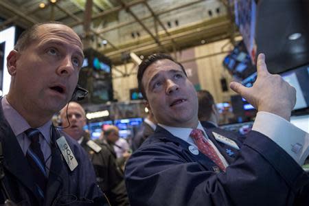 Traders work on the floor of the New York Stock Exchange February 12, 2014. REUTERS/Brendan McDermid