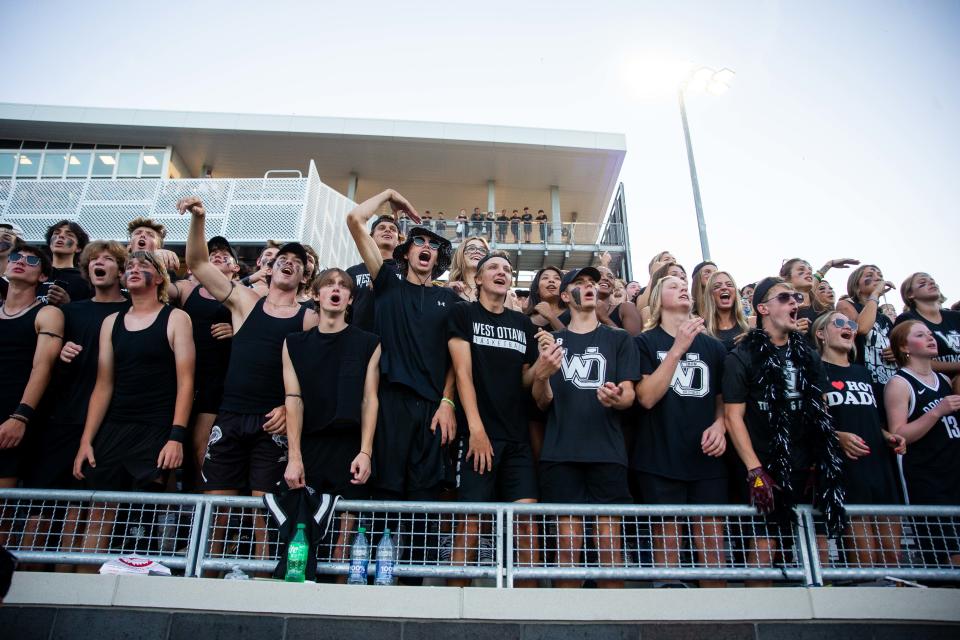 A full student section cheers for their team as they play the first ever game at the new football stadium Thursday, Sept. 1, 2022, at West Ottawa Stadium. 