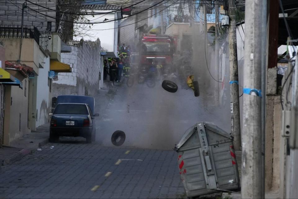 Police carry out a controlled explosion of a suspicious vehicle parked a block from El Inca prison, in Quito (AP)