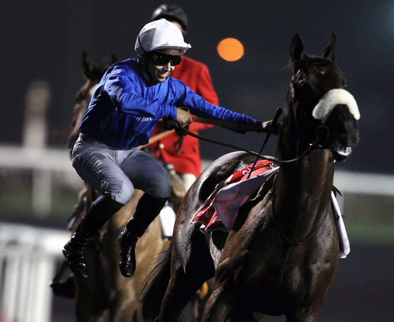 French jockey Mikael Barzalona jumps off