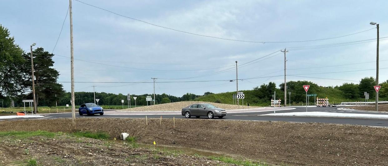 Cars travel through the new roundabout at Refugee Road and Etna Parkway at the border between Pataskala and Etna Township on Monday. The Licking County Transportation Improvement District is in the end stages of a year-long, $11.2-million road improvement project to widen Refugee Road to three lanes from Mink Street to Etna Parkway with roundabouts at each intersection.
