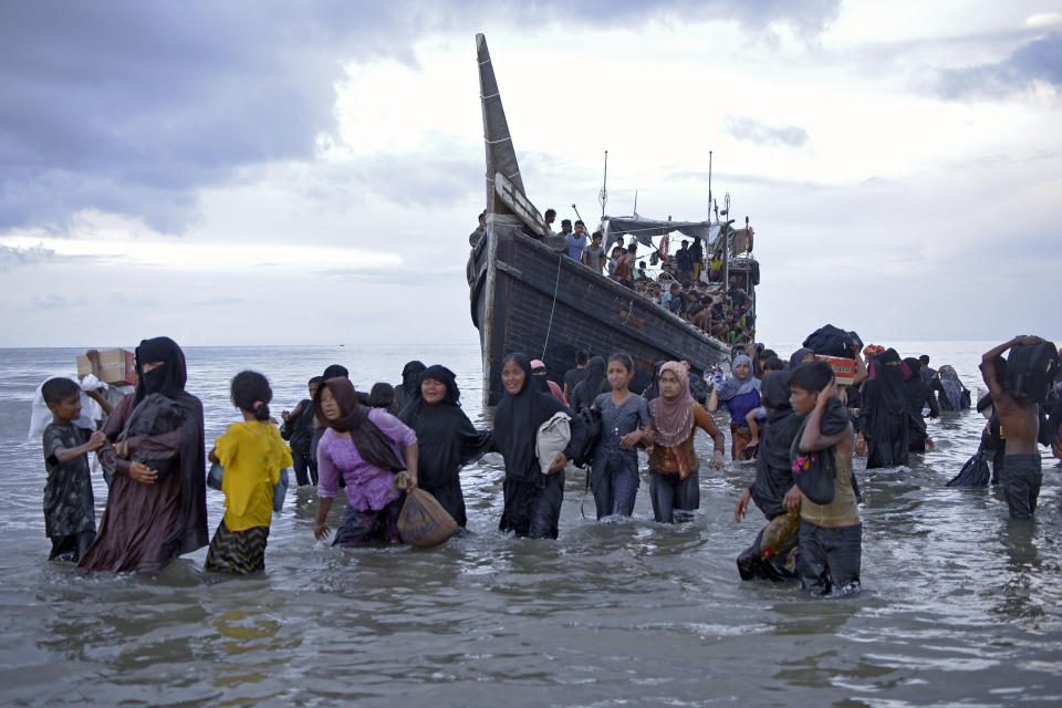 Ethnic Rohingya disembark from their boat upon landing in Ulee Madon, North Aceh, Indonesia, Thursday, Nov. 16, 2023. Some 240 Rohingya Muslims, including women and children, are afloat off the coast of Indonesia after two attempts to land were rejected by local residents. The boat left again a few hours later following the rejection. (AP Photo/Rahmat Mirza)