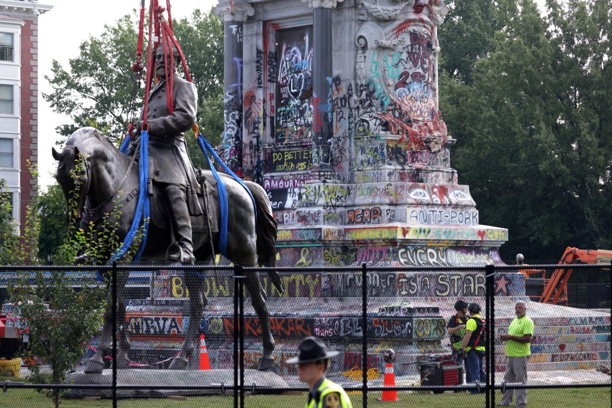 The statue of Robert E. Lee stands on the ground after it was lowered from its pedestal at Robert E. Lee Memorial during its removal on Sept. 8, 2021, in Richmond, Va.