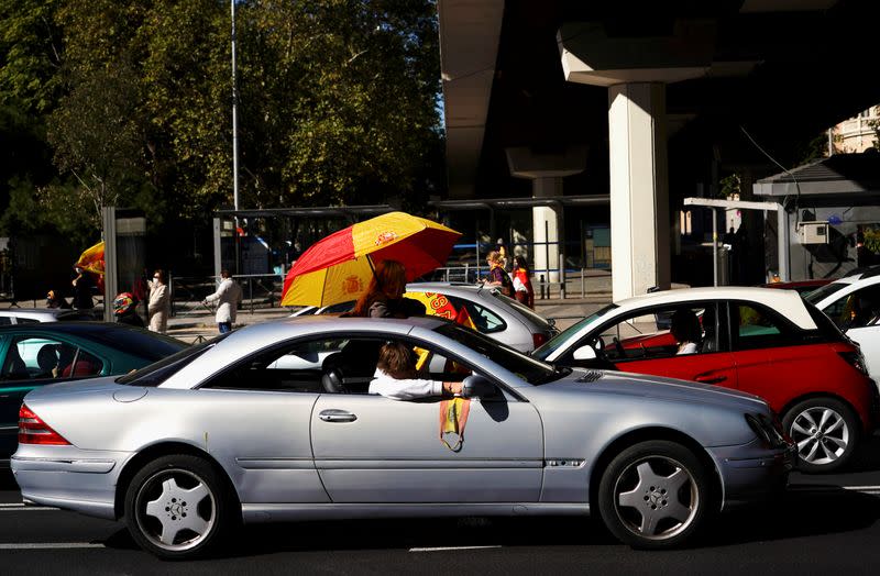 People protest in their vehicles against the state of emergency in a demonstration organized by the far-right party Vox on Spain's national day amid the outbreak of the coronavirus disease (COVID-19) in Madrid