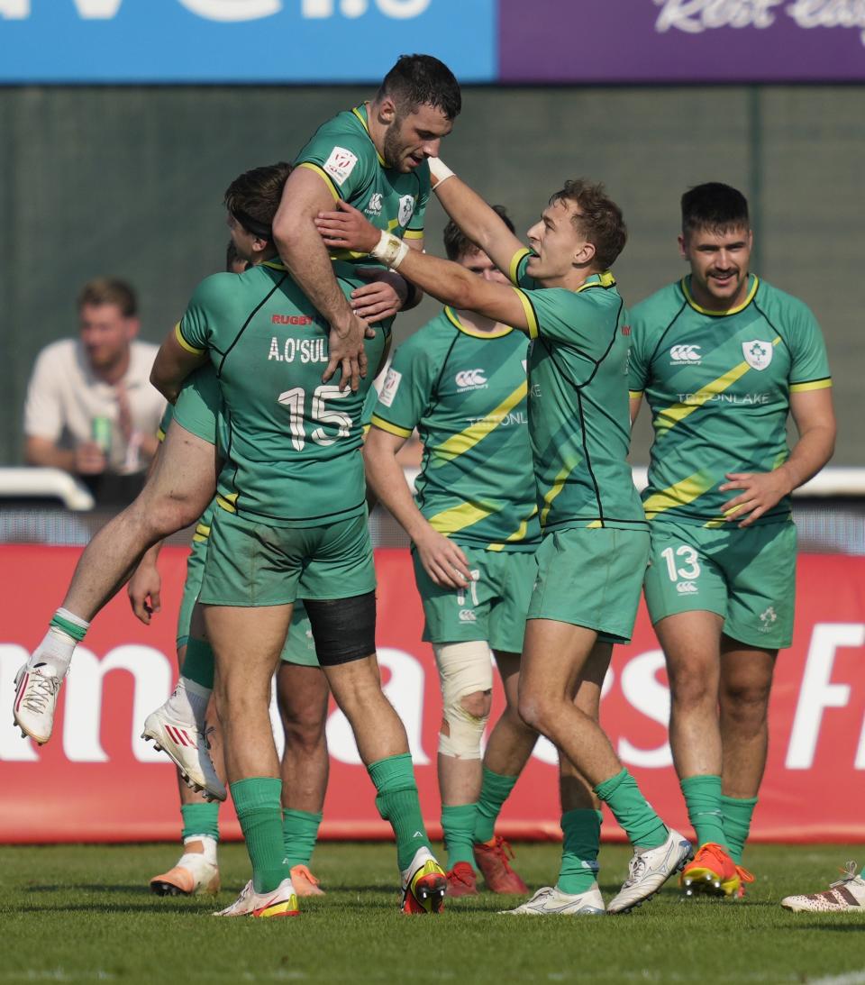 Ireland's players celebrate after they beat the U.S. during a semi final match of the Emirates Airline Rugby Sevens, in Dubai, United Arab Emirates, Saturday, Dec. 3, 2022. (AP Photo/Kamran Jebreili)