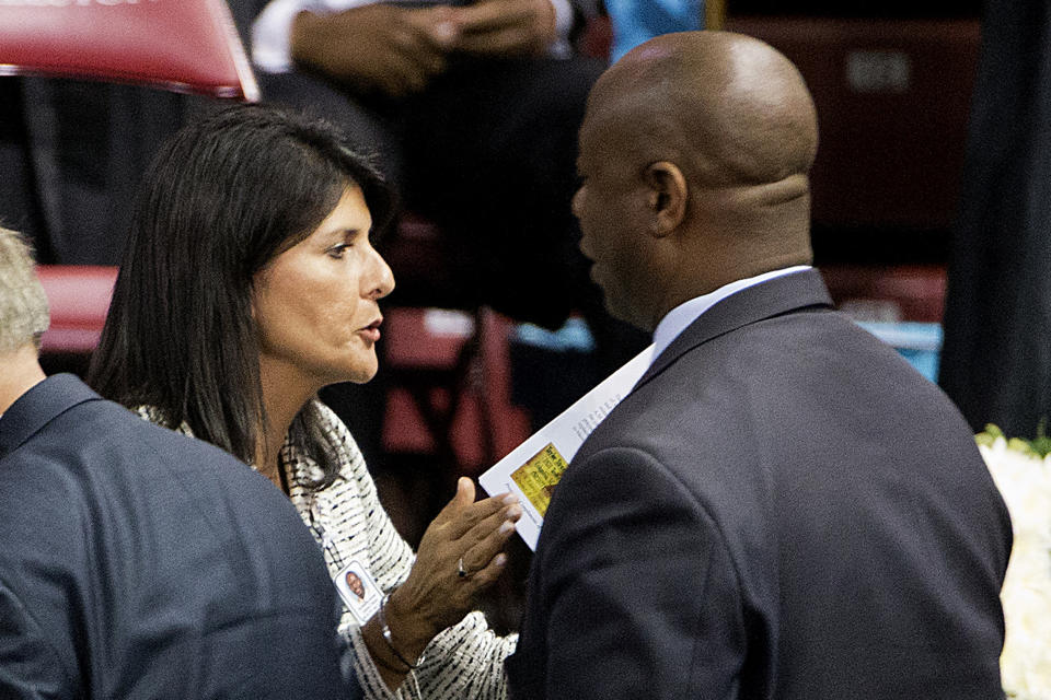 FILE - Sen. Tim Scott, R-S.C., right, talks with South Carolina Gov. Nikki Haley at the funeral service for Rev. Clementa Pinckney, June 26, 2015, in Charleston, S.C. As the 2024 Republican field begins to take shape, the potential of a faceoff between Haley and Scott is putting some of their mutual supporters in the critical early-voting state of South Carolina in a conundrum as they weigh which candidate to support. (AP Photo/David Goldman, File)