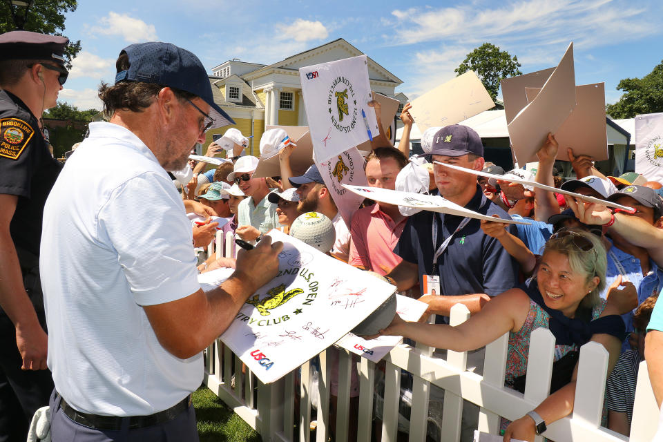 Brookline, MA - June 15: Phil Mickelson is mobbed by fans at the 18th as he signs autographs after his practice round. Players took practice rounds and toned their golfing skills at the driving range at The Country Club in Brookline, MA on June 15, 2022 in preparation for Thursdays start of the US Open. (Photo by John Tlumacki/The Boston Globe via Getty Images)