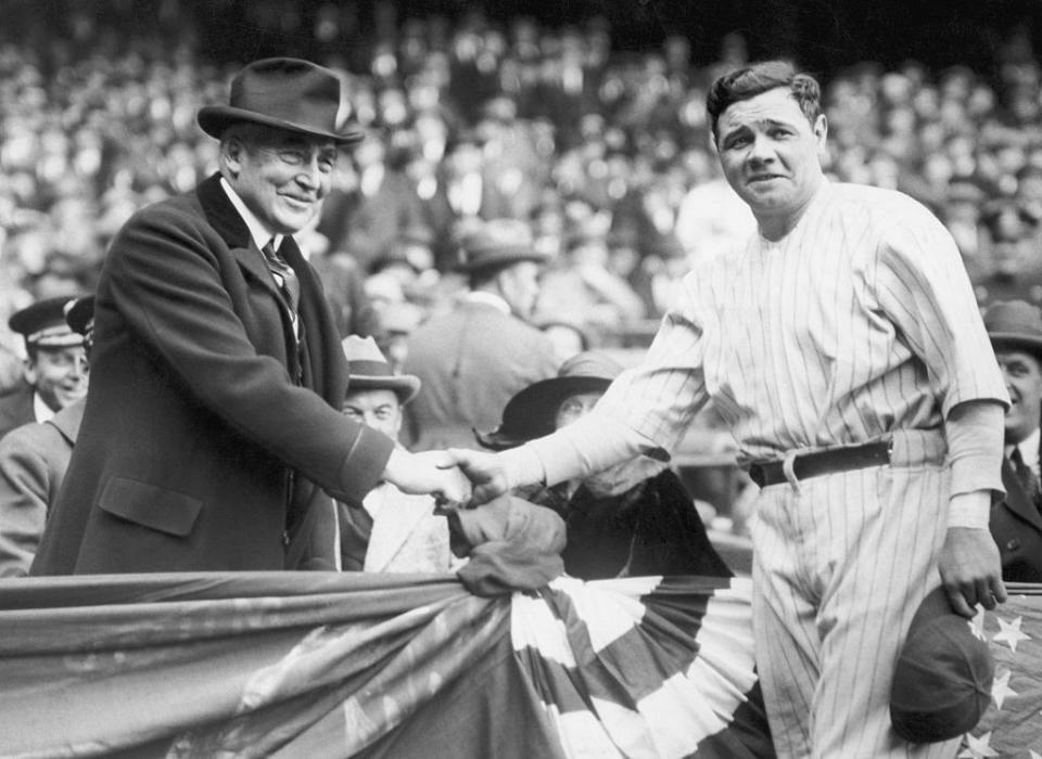 President Warren G. Harding shakes hands with New York Yankee player Babe Ruth.