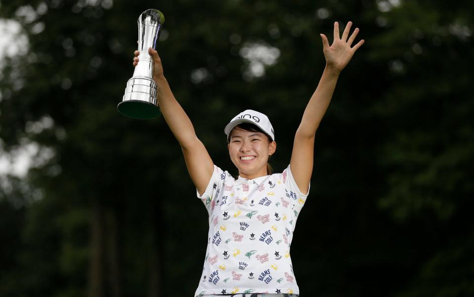 Japan's Hinako Shibuno reacts as she holds the trophy as she celebrates after winning the Women's British Open golf championship at Woburn - AP Photo/Tim Ireland