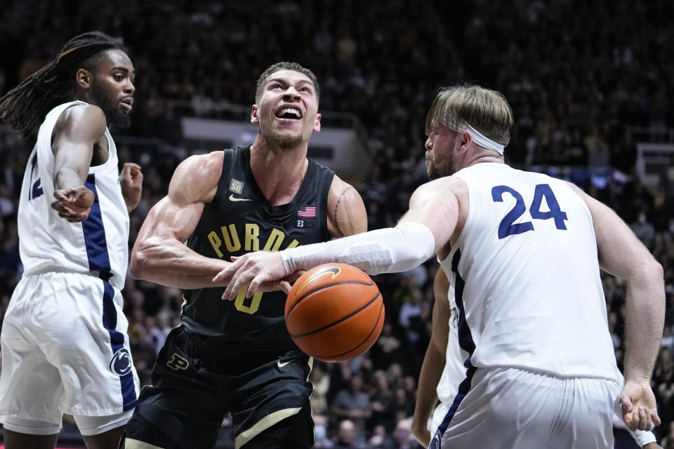 Purdue forward Mason Gillis (0) is fouled by Penn State forward Michael Henn (24) as he shoots during the second half of an NCAA college basketball game in West Lafayette, Ind., Wednesday, Feb. 1, 2023. Purdue defeated Penn State 80-60. (AP Photo/Michael Conroy)