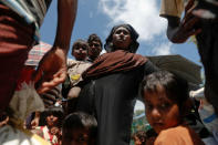 Rohingya refugees who arrived by boat fleeing violence in Myanmar the night before, wait to be transported to camps from a relief centre at Teknaf near Cox's Bazar, Bangladesh October 4, 2017. REUTERS/Damir Sagolj