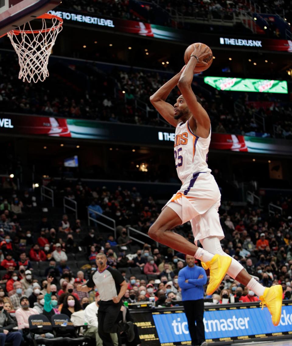 Phoenix Suns' Mikal Bridges dunks during the first half of an NBA basketball game against the Washington Wizards, Saturday, Feb. 5, 2022, in Washington. (AP Photo/Luis M. Alvarez)