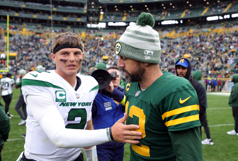 GREEN BAY, WISCONSIN - OCTOBER 16: Aaron Rodgers #12 of the Green Bay Packers and Zach Wilson #2 of the New York Jets shake hands after the game at Lambeau Field on October 16, 2022 in Green Bay, Wisconsin. (Photo by Stacy Revere/Getty Images)