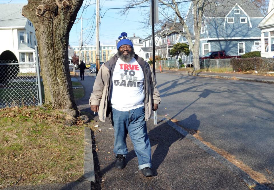 Arthur Dickerson is all smiles as he walks through his North Quincy neighborhood on Thursday, Dec. 2, 2021.