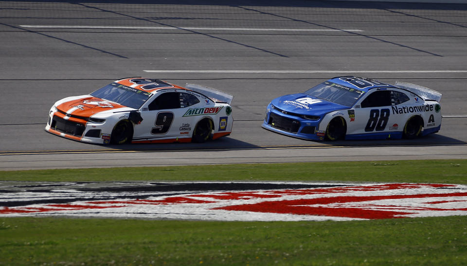 Chase Elliott (9) leads Monster Energy NASCAR Cup Series driver Alex Bowman (88) through the trip oval to win Stage 2 during a NASCAR Cup Series auto race at Talladega Superspeedway, Sunday, April 28, 2019, in Talladega, Ala. (AP Photo/Butch Dill)