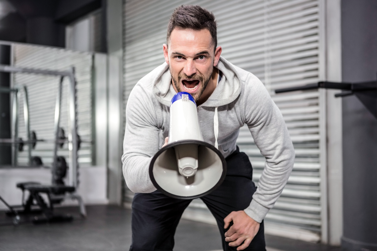 Personal trainer yelling into a megaphone