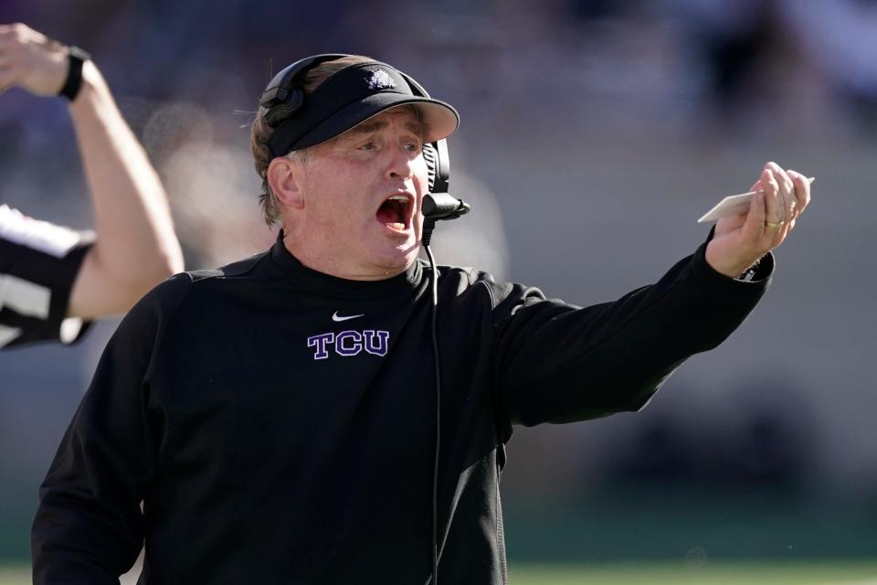 TCU head coach Gary Patterson talks to his players during the first half of an NCAA college football game against Kansas State, Saturday, Oct. 30, 2021, in Manhattan, Kan.