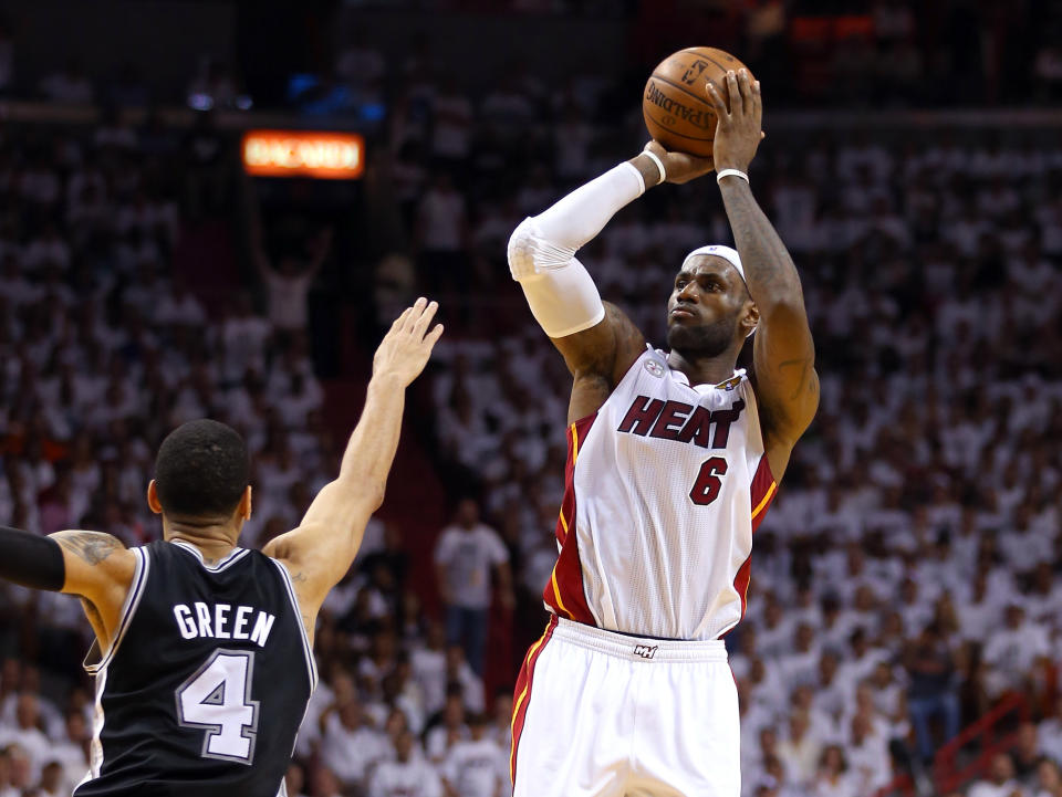 MIAMI, FL - JUNE 20:  LeBron James #6 of the Miami Heat makes a three-pointer over Danny Green #4 of the San Antonio Spurs in the second quarter during Game Seven of the 2013 NBA Finals at AmericanAirlines Arena on June 20, 2013 in Miami, Florida. NOTE TO USER: User expressly acknowledges and agrees that, by downloading and or using this photograph, User is consenting to the terms and conditions of the Getty Images License Agreement.  (Photo by Mike Ehrmann/Getty Images)