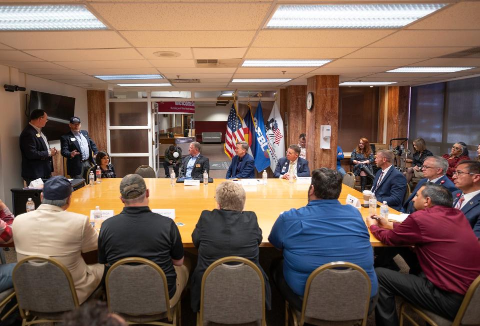 Sen. John Hickenlooper, center back, listens to a presentation during a meeting with veterans at Mt. Carmel Veteran Center on Thursday, April 4, 2024.