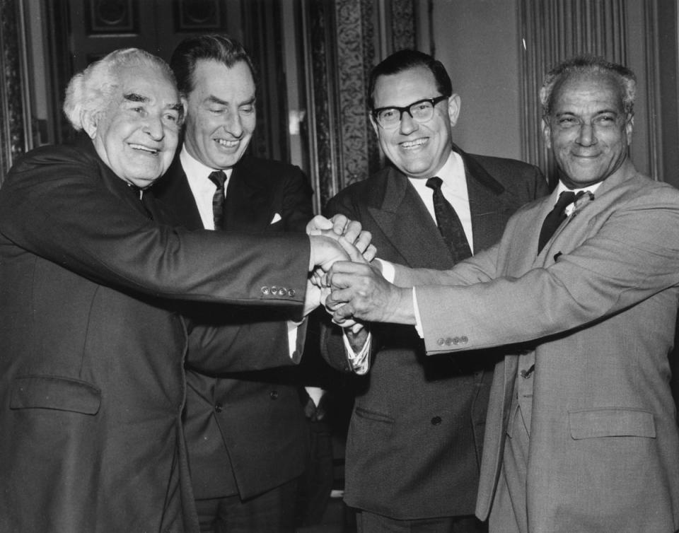 9th February 1962:  L to r Sir William Alexander Bustamante (1884 - 1977) head of the Jamaican Opposition party, Hugh Frazer of the Colonial office, Colonial Secretary, Reginald Maudling (1917 - 1979) and President of Jamaica, Norman Manley (1893 - 1969) join hands in a gesture of solidarity after the final session of the Jamaica Independence Conference held at Lancaster House, London. Independence day was to be 6th August (John Franks/Keystone/Getty Images)