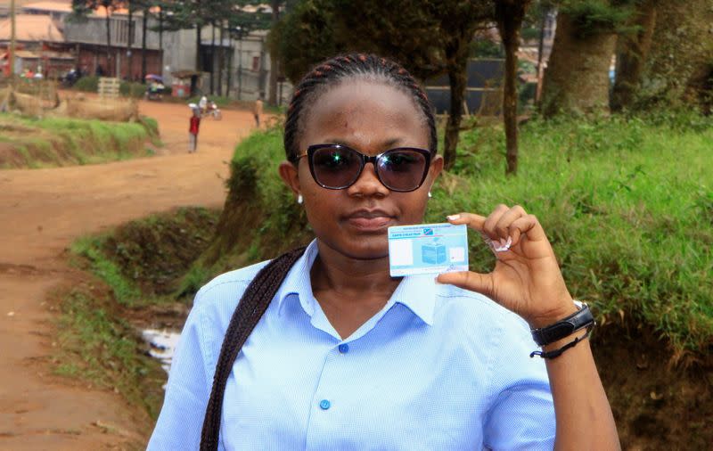 Stephanie Mbafumoja, a Congolese law student holds her voter identity card in L'avenue de L'itav in Butembo