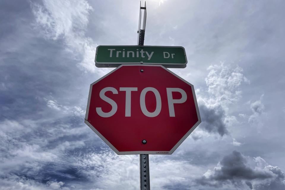 A street sign stands on Aug. 13, 2023, along one of the main drives in Los Alamos, N.M., that references the 1945 Trinity Test. Los Alamos was the perfect spot for the U.S. government's top-secret effort to build the world's first atomic bomb. The community is facing growing pains again, 80 years later, as it works to modernize the country's nuclear arsenal. (AP Photo/Susan Montoya Bryan)