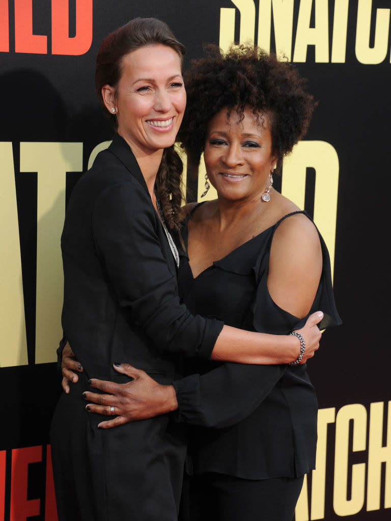 Alex and Wanda Sykes with their arms around each other