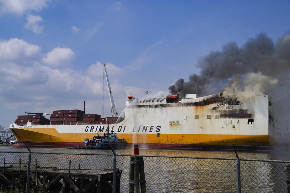 FILE - Emergency personnel battle against a fire aboard the Italian-flagged Grande Costa d'Avorio cargo ship at the Port of Newark, Friday, July 7, 2023, in Newark, N.J. On Wednesday, Jan. 10, 2024, the U.S. Coast Guard and the National Transportation Safety Board began a series of investigative hearings into the cause of the fire, and plan to issue recommendations to avoid similar incidents in the future.(AP Photo/John Minchillo, File)