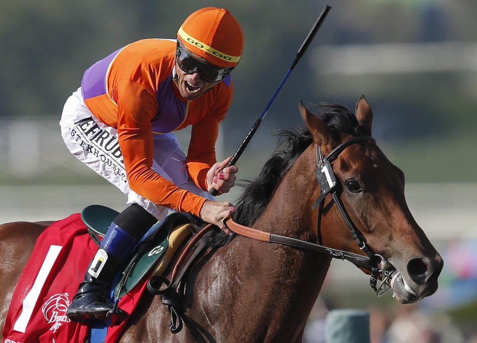 FILE - In this Nov. 2, 2012, file photo, jockey Garrett Gomez reacts aboard Beholder after crossing the finish line to win the Juvenile Fillies horse race at the Breeders' Cup in Arcadia, Calif. Gomez, who won nearly 4,000 races in a 25-year career and was among the greatest jockeys of the first decade of the 21st century, has died in southern Arizona. He was 44. Authorities with the Pascua Yaqui Tribe said Thursday, Dec. 15, 2016, that Gomez was found unconscious on the floor of a hotel room Wednesday and pronounced dead at the scene. They say foul play isn't suspected(AP Photo/Jae C. Hong, File)