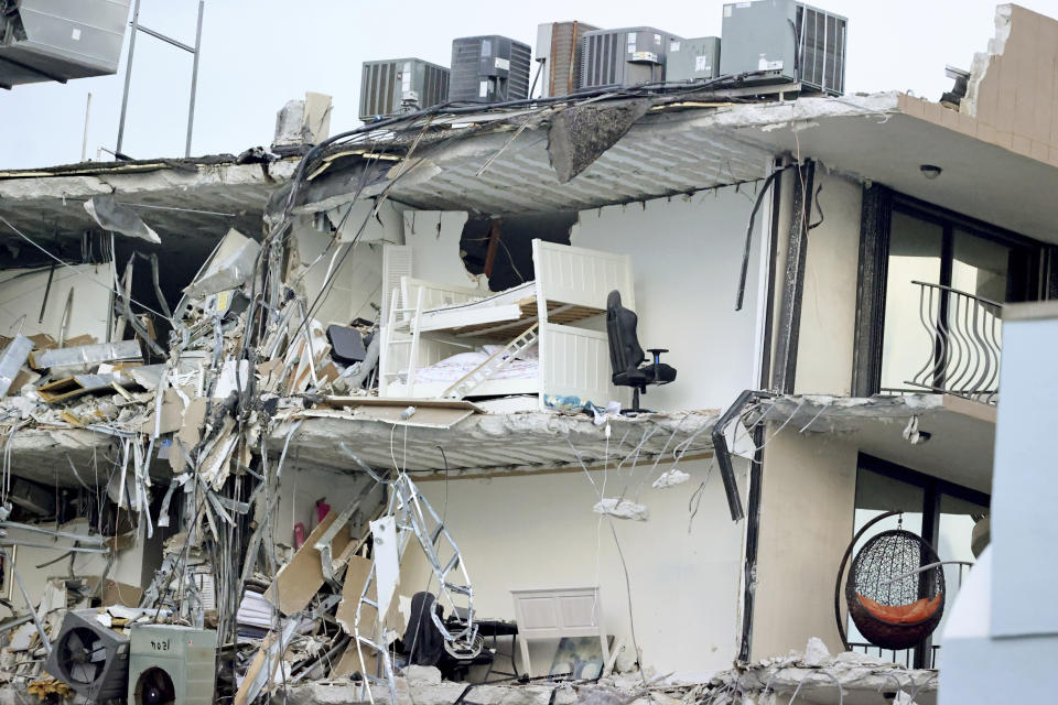 Debris dangles from Champlain Towers South Condo after the multistory building partially collapsed Thursday, June 24, 2021, in Surfside, Fla. (David Santiago /Miami Herald via AP)