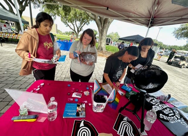 Students at Polk State College in Lakeland sign petitions in October for a proposed constitutional amendment that would establish abortion rights in Florida.