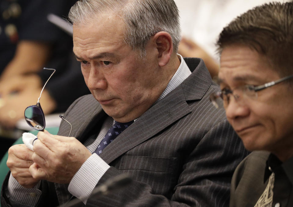 Secretary of Foreign Affairs Teodoro Locsin Jr. wipes his eyeglass during a senate hearing in Manila, Philippines on Thursday, Feb. 6, 2020. The Philippine foreign secretary warned Thursday that abrogating a security accord with Washington would undermine his country's security and foster aggression in the disputed South China Sea. (AP Photo/Aaron Favila)