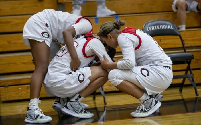 CORONA, CA - JUNE 10, 2021: Corona Centennial teammates Jayda Curry (30), Trinity San Antonio (23), middle, and Bella Law (2) console each other after losing to Mater Dei in overtime in the Southern Section Open Division Championship on June 10 2021 in Corona, California.(Gina Ferazzi / Los Angeles Times)