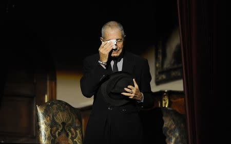 Canadian singer-songwriter Leonard Cohen cries during a tribute in Gijon, northern Spain on October 19, 2011. REUTERS/Eloy Alonso/File Photo