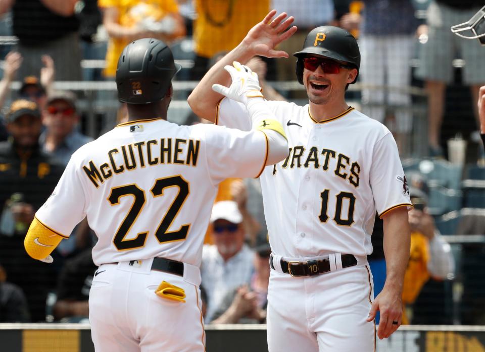 Andrew McCutchen and Bryan Reynolds react after a homer against the Rockies.