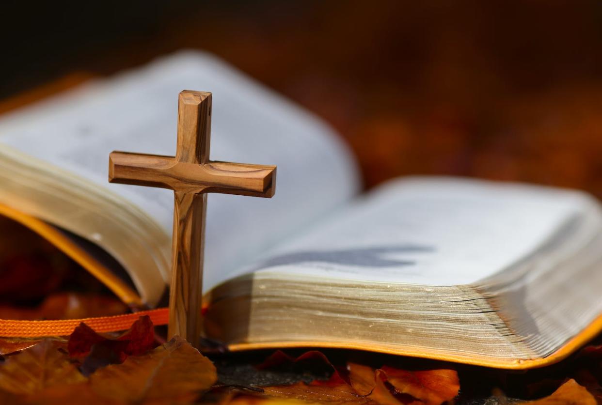 Many prominent Christians believe in inerrancy, or that the Bible is without error. <a href="https://www.gettyimages.com/detail/news-photo/open-bible-and-christian-cross-on-dry-fallen-autumn-leaves-news-photo/1314859041?adppopup=true" rel="nofollow noopener" target="_blank" data-ylk="slk:Godong/Universal Images Group via Getty Images;elm:context_link;itc:0;sec:content-canvas" class="link ">Godong/Universal Images Group via Getty Images</a>