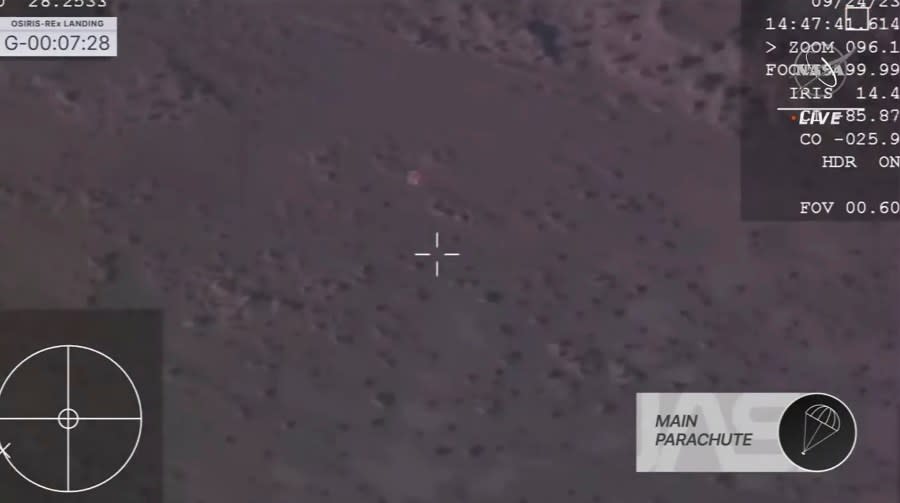 This image taken from video provided by NASA TV shows the capsule released by the Osiris-Rex spacecraft parachuting down to Earth, Sunday Sept. 24 2023. (NASA TV via AP)