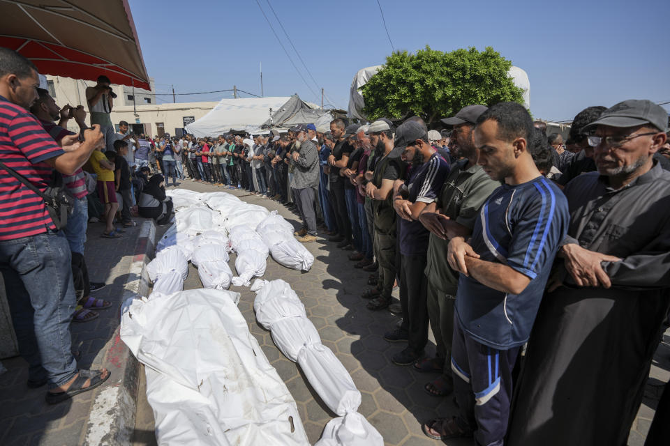 Palestinians mourn relatives killed in an Israeli strike on a U.N.-run school in the Nusseirat refugee camp, outside a hospital in Deir al Balah, Gaza Strip, Thursday, June 6, 2024. The Israeli military said that Hamas militants were operating from within the school. (AP Photo/Abdel Kareem Hana)