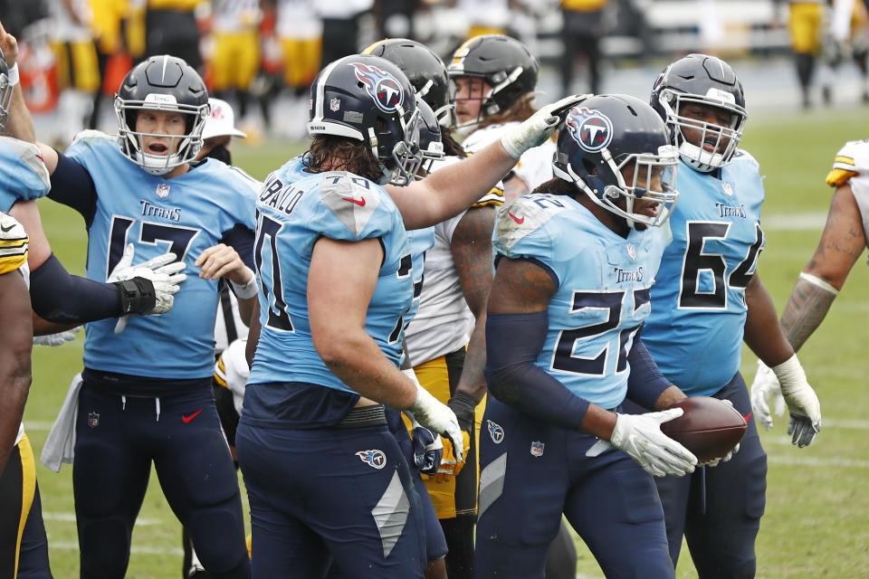 Tennessee Titans running back Derrick Henry (22) is congratulated by offensive tackle Ty Sambrailo (70) after Henry scored a touchdown against the Pittsburgh Steelers in the second half of an NFL football game Sunday, Oct. 25, 2020, in Nashville, Tenn. (AP Photo/Wade Payne)