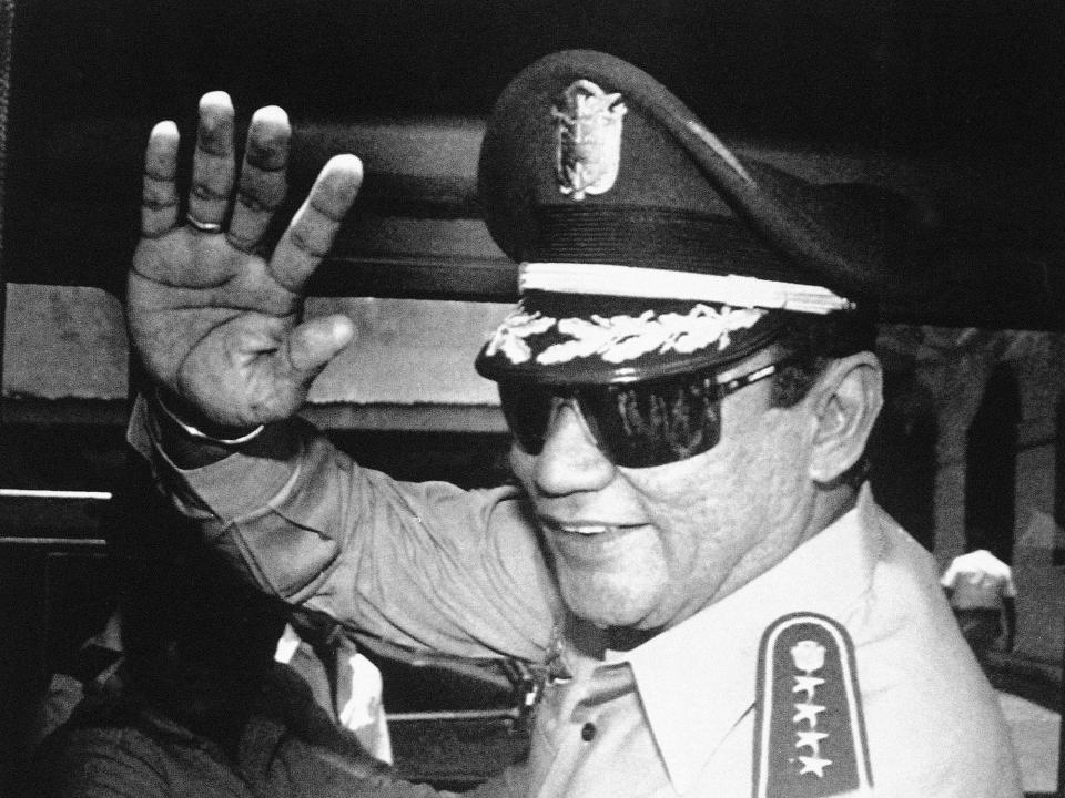 <p>Gen. Manuel Antonio Noriega waves to the media after a state council meeting at the presidential palace in Panama City, where the council announced the new president of the republic, Aug. 31, 1989 . (AP Photo/Matias Recart, File) </p>