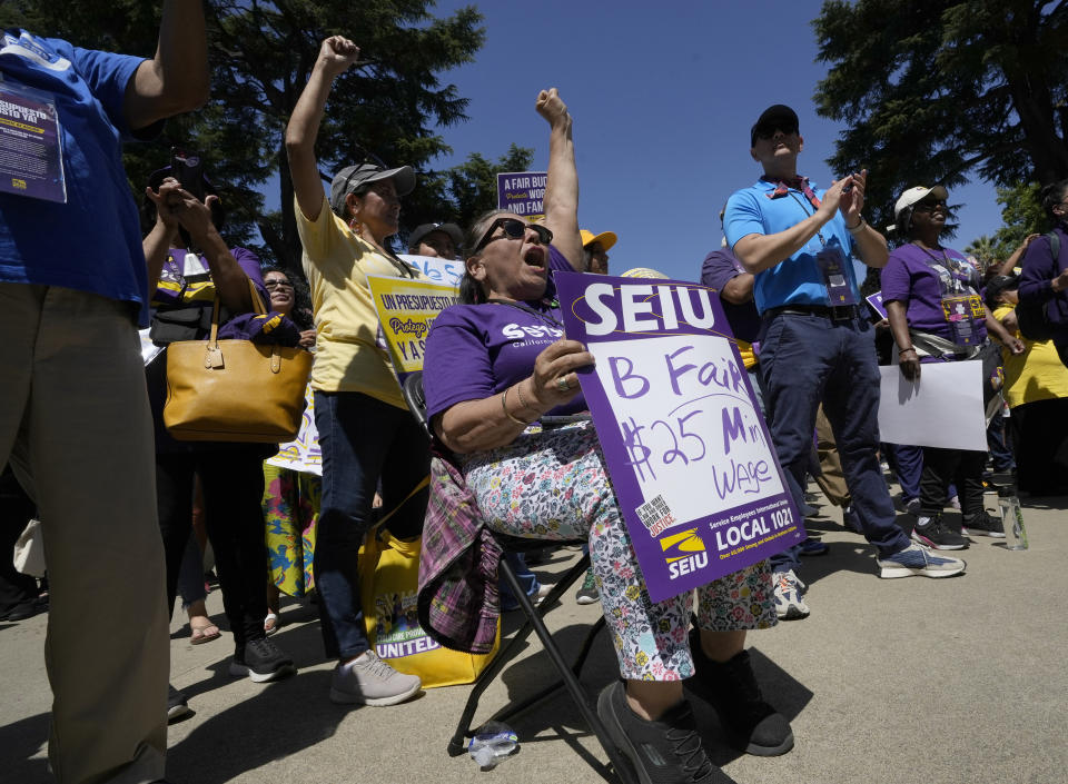 Maria Grijaiva, front, joins other supporters of the Service Employees International Union at a rally against proposed budget cuts to state provided social safety net programs, in Sacramento, Calif., Tuesday, June 11, 2024. The California Legislature on Thursday, June 13, rejected many of Gov. Gavin Newsom's most difficult budget cuts, choosing instead to speed-up a temporary tax increase on some businesses to help pay off an estimated $45 billion deficit while preserving spending on many social safety net programs. (AP Photo/Rich Pedroncelli)